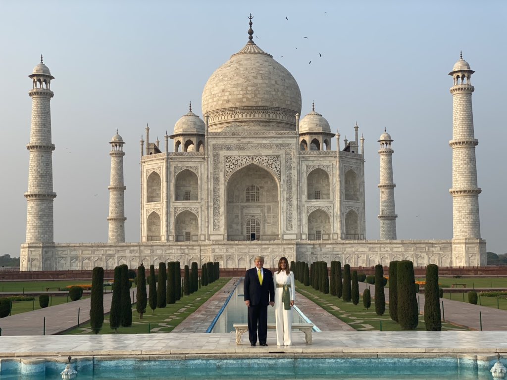 Trump and Melania Trump standing in front of Taj Mahal
